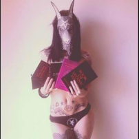 Satanic Woman Holds Book of Satanic Magic by Aleister Nacht